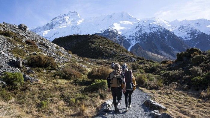 Hikers walk in the Hooker Valley track at Aoraki / Mount Cook National Park in the South Island, New Zealand, on August 05, 2020. The lookout point at the end of the Hooker Valley Track ends with an iceberg-speckled Hooker Lake and closest view of Aoraki / Mount Cook. Mount Cook lies amidst the Southern Alps Mountain range and as of 2020, its height is recorded as 3724m from the sea level. (Photo by Sanka Vidanagama/NurPhoto via Getty Images)