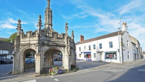 Market Cross, Malmesbury hilltop town centre, Wiltshire, England. On a hilltop site, Malmesbury was once marked by an iron age fort and later became one of the most significant towns in England,. Situated on the River Avon, it features the Abbey, now over one thousand years old and other quaint and distinctive architecture that maps the centuries.