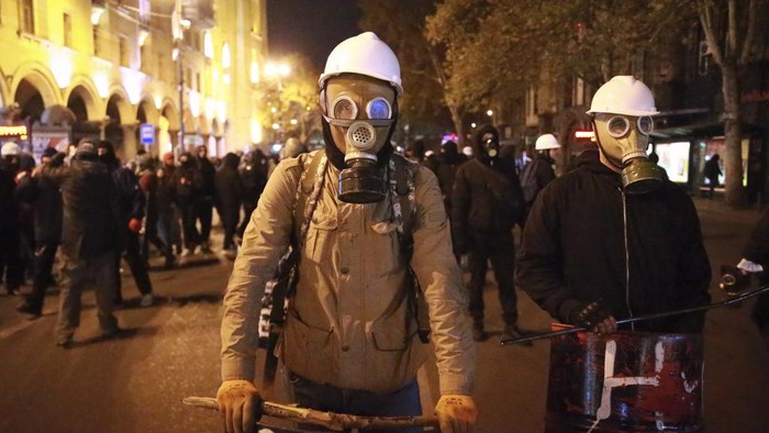 Demonstrators use lasers towards the police during a rally outside the parliament to protest against the government's decision to suspend negotiations on joining the European Union in Tbilisi, Georgia, on Tuesday, Dec. 3, 2024. (AP Photo/Zurab Tsertsvadze)