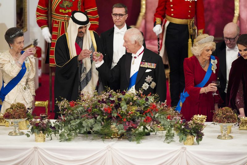 Britain's King Charles III, centre, and Queen Camilla, second right, with the Emir of Qatar Sheikh Tamim bin Hamad Al Thani, second left, and Britain's Princess Anne, left, during a State Banquet at Buckingham Palace, in London, Tuesday, Dec. 3, 2024, during the state visit to the U.K. of the Emir of Qatar and the first of his three wives. (Jordan Pettitt/Pool Photo via AP)