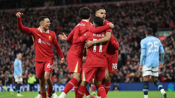 LIVERPOOL, ENGLAND - DECEMBER 01: Cody Gakpo of Liverpool celebrates scoring his teams first goal with Dominik Szoboszlai and Mohamed Salah during the Premier League match between Liverpool FC and Manchester City FC at Anfield on December 01, 2024 in Liverpool, England. (Photo by Carl Recine/Getty Images)