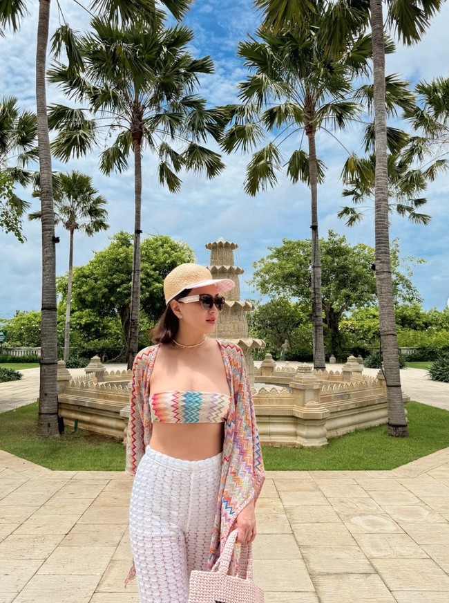 Bergaya bak ABG, Shandy tampil memamerkan perut ratanya dengan mengenakan setelan atasan dan outer bikini bermotif zig-zag. Penampilannya itu kemudian dipadukan dengan celana putih. Foto: Instagram/@shandyaulia