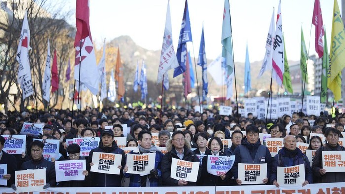 South Koreans hold signs reading 