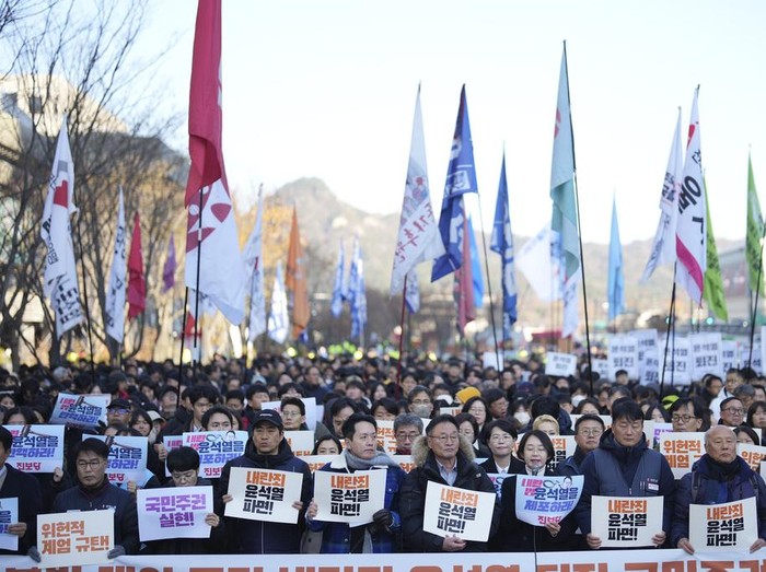 South Koreans hold signs reading 