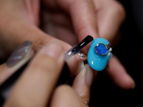 Japanese manicurist Naomi Arimoto presses a false nail with a decorative nail tip using plastic waste which she collected from the beach, onto a thumb of a customer at her nail salon in Chigasaki, Kanagawa Prefecture, Japan October 21, 2024. REUTERS/Manami Yamada