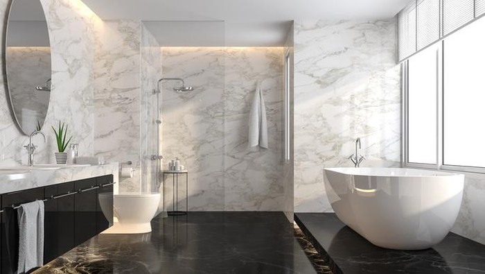 Luxury bathroom with black marble floor and white marble wall 3d render,The room has a clear glass shower partition,There are large windows natural light shining into the room.