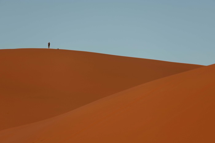 A man stands at the top of a dune at the Erg Chebbi sand dunes in the Sahara desert outside Merzouga, Morocco December 5, 2024. REUTERS/Darrin Zammit Lupi