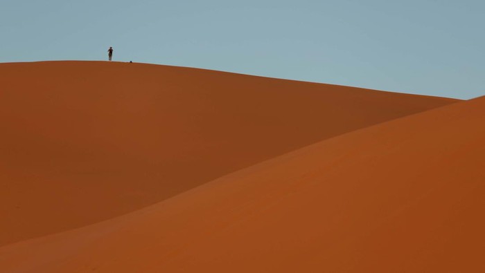 A man stands at the top of a dune at the Erg Chebbi sand dunes in the Sahara desert outside Merzouga, Morocco December 5, 2024. REUTERS/Darrin Zammit Lupi