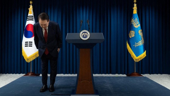 This handout photo taken and released on December 7, 2024 by the South Korean Presidential Office shows South Koreas President Yoon Suk Yeol bowing after the end of his address at the Presidential Office in Seoul. South Koreas embattled President Yoon Suk Yeol stopped short of resigning on December 7 over his declaration of martial law, with a vote to impeach him hours away and mass street protests planned in Seoul. (Photo by Handout / South Korean Presidential Office / AFP) / RESTRICTED TO EDITORIAL USE - MANDATORY CREDIT 