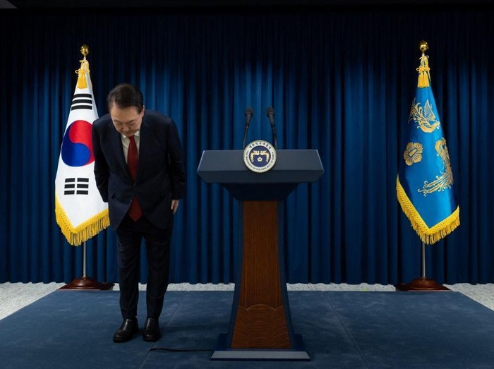 This handout photo taken and released on December 7, 2024 by the South Korean Presidential Office shows South Koreas President Yoon Suk Yeol bowing after the end of his address at the Presidential Office in Seoul. South Koreas embattled President Yoon Suk Yeol stopped short of resigning on December 7 over his declaration of martial law, with a vote to impeach him hours away and mass street protests planned in Seoul. (Photo by Handout / South Korean Presidential Office / AFP) / RESTRICTED TO EDITORIAL USE - MANDATORY CREDIT 