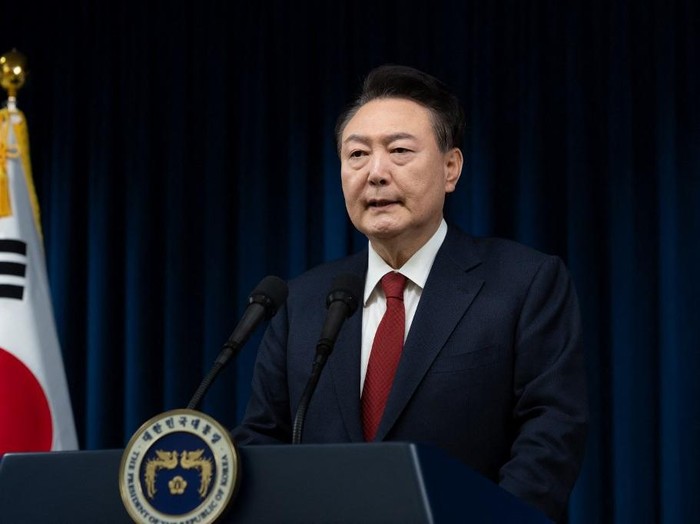 This handout photo taken and released on December 7, 2024 by the South Korean Presidential Office shows South Koreas President Yoon Suk Yeol delivering an address at the Presidential Office in Seoul. South Koreas embattled President Yoon Suk Yeol stopped short of resigning on December 7 over his declaration of martial law, with a vote to impeach him hours away and mass street protests planned in Seoul. (Photo by Handout / South Korean Presidential Office / AFP) / RESTRICTED TO EDITORIAL USE - MANDATORY CREDIT 