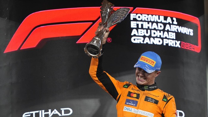 McLaren driver Lando Norris of Britain stands on the podium after winning the Formula One Abu Dhabi Grand Prix at the Yas Marina Circuit in Abu Dhabi, UAE, Sunday, Dec. 8, 2024. (AP Photo/Darko Bandic)