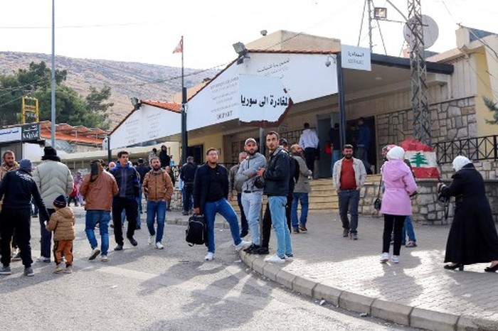 Syrians return to Damascus via Lebanons Masnaa border crossing east of Beirut on December 8, 2024, following the fall of the Syrian capital to anti-government fighters. Islamist-led rebels took Damascus on December 8 after a lightning offensive, sending President Bashar al-Assad fleeing and ending five decades of Baath party rule in Syria. (Photo by Hassan JARRAH / AFP)