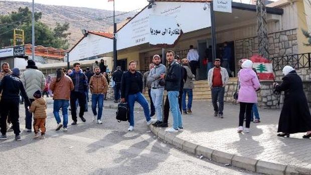 Syrians return to Damascus via Lebanon's Masnaa border crossing east of Beirut on December 8, 2024, following the fall of the Syrian capital to anti-government fighters. Islamist-led rebels took Damascus on December 8 after a lightning offensive, sending President Bashar al-Assad fleeing and ending five decades of Baath party rule in Syria. (Photo by Hassan JARRAH / AFP)