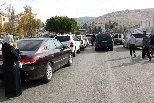 Syrians return to Damascus via Lebanon's Masnaa border crossing east of Beirut on December 8, 2024, following the fall of the Syrian capital to anti-government fighters. Islamist-led rebels took Damascus on December 8 after a lightning offensive, sending President Bashar al-Assad fleeing and ending five decades of Baath party rule in Syria. (Photo by Hassan JARRAH / AFP)