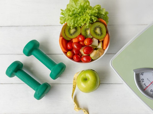 Diet Health food and lifestyle health concept. Sport exercise equipment workout with green apple and measuring tap, fresh salad for fitness style. Healthy Lifestyle Concept
