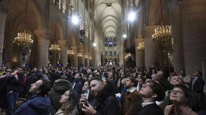 Clergymen leave after the first public mass in Notre Dame Cathedral since the 2019 fire, Sunday, Dec. 8, 2024 in Paris. (AP Photo/Michel Euler)