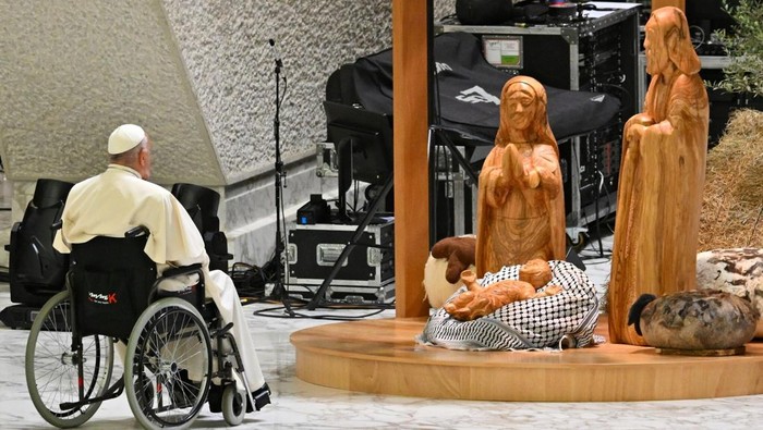 Pope Francis prays before the Nativity of Bethlehem 2024, upon its inauguration in the Paul VI Hall, during the private audience with donors of the nativity scene and the lighting of the Christmas tree ceremony at St Peters Square, in the Paul-VI hall at the Vatican on December 7, 2024. (Andreas Solaro/ AFP)