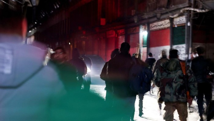 People walk at Al-Hamidiyah Souq, after rebels seized the capital and ousted Syria's Bashar al-Assad, in Damascus, Syria December 9, 2024. REUTERS/Mohamed Azakir