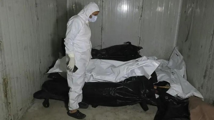 A sanitary serviceman stands by body bags at the morgue of a hospital in Damascus on December 10, 2024. (AFP)