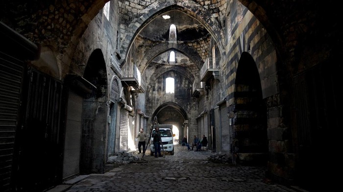 Potret Aleppo, Kota Tua yang Masih Berpenghuni Men restore a wall at the Old City, after Syrian rebels announced that they have ousted Bashar al-Assad, in Aleppo, Syria, December 9, 2024. REUTERS/Karam al-Masri