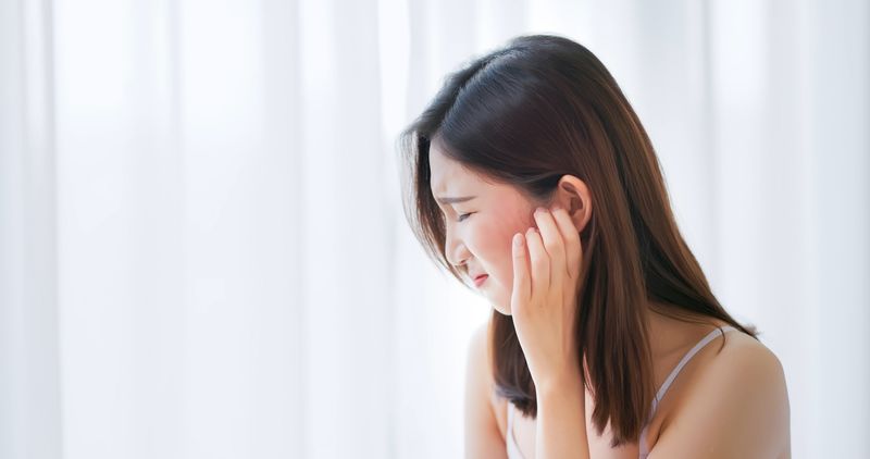 asian beauty woman has dry skin and scratching her face