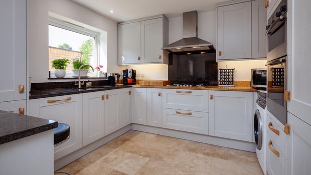 Modern contemporary shaker style fitted kitchen with built in appliances breakfast bar and granite counbter tops