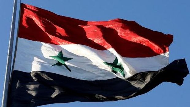 (FILES) A picture taken on June 27, 2018 shows a Syrian national flag fluttering during the opening of a flower show at Tishreen Park in the capital Damascus. With the fall of president Bashar al-Assad on December 8, 2024, the three-starred independence-era flag adopted by activists and rebels during the 2011 revolt has replaced the official flag on streets around Syria. (Photo by LOUAI BESHARA / AFP)