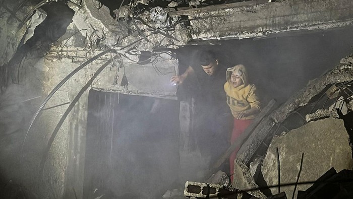 A person is placed inside an ambulance following an Israeli strike at a post office where people were sheltering in Nuseirat in central Gaza Strip December 12, 2024. REUTERS/Khamis Said