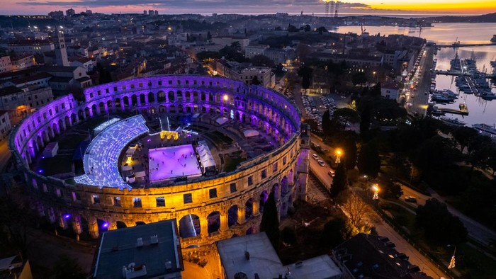 A drone view shows a skating ring at the Advent market at the Amphitheatre during the sunset, in Pula, Croatia, December 12, 2024. REUTERS/Antonio Bronic