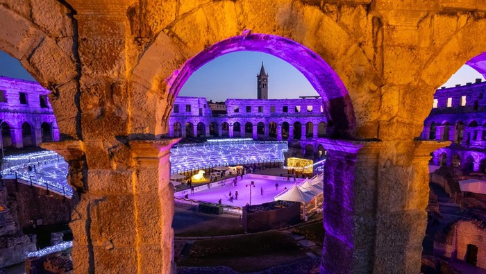 A drone view shows a skating ring at the Advent market at the Amphitheatre during the sunset, in Pula, Croatia, December 12, 2024. REUTERS/Antonio Bronic