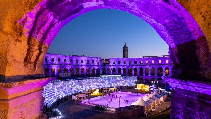 A drone view shows a skating ring at the Advent market at the Amphitheatre during the sunset, in Pula, Croatia, December 12, 2024. REUTERS/Antonio Bronic