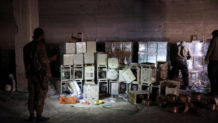 Fighters loyal to Syria's new ruling administration, inspect a building they claim to be a captagon factory, on the outskirts of Damascus, Syria, December 12, 2024. REUTERS/Mohamed Azakir