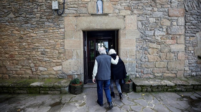 People sit inside Hostal De Pinos, which this year celebrates 500 years of serving food continuously, in Pinos town, north of Barcelona, Spain, November 7, 2024. REUTERS/Albert Gea