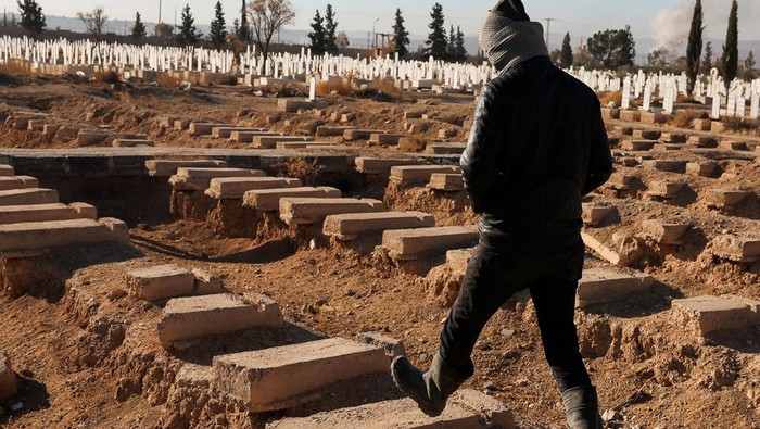 Abo Khaled, a farmer walks by the site of a mass grave from the rule of Syria's Bashar al-Assad, according to residents, after the ousting of al-Assad, in Najha, Syria, December 15, 2024. REUTERS/Amr Abdallah Dalsh