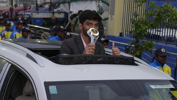 Gukesh Dommaraju poses with a trophy during a procession held to honor him on becoming the World youngest chess champion in Chennai, India, Tuesday, Dec. 17, 2024. (AP Photo/Mahesh Kumar A.)