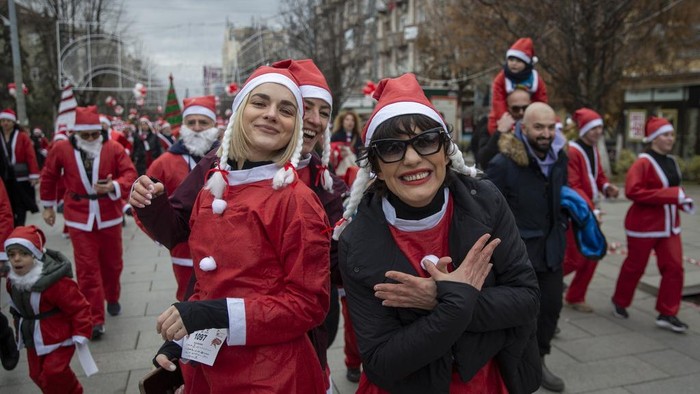 Thousands of Kosovars donned their festive attire for the annual Christmas theme charity run of Santas flooding the streets of Kosovo's capital on Sunday, Dec 15, 2024. The annual tradition seeks to gather funds for families in need. (AP Photo/Visar Kryeziu)