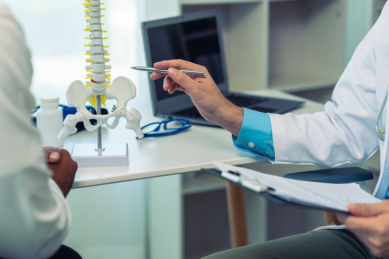 Male doctor counseling patient about osteoarthritis Bone or knee joint, health care concept, doctor explains symptoms and treatment Close-up pictures