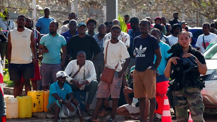 People wait to get fuel, in the aftermath of Cyclone Chido, in Dzaoudzi, Mayotte, December 20, 2024. REUTERS/Gonzalo Fuentes
