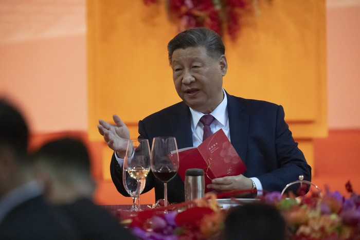 Chinese President Xi Jinping gestures as he talks to leaders during a welcoming dinner, ahead of celebrations for the 25th anniversary of Macaos handover from Portugal to China, in Macao, Thursday, Dec. 19, 2024. (AP Photo/Anthony Kwan, Pool)