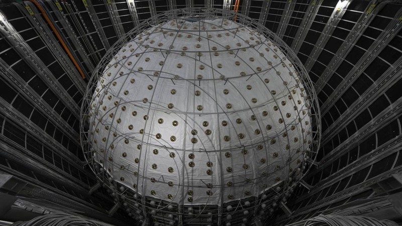Workers labor on the underside of the cosmic detector located 2297 feet (700 meters) underground at the Jiangmen Underground Neutrino Observatory in Kaiping, southern China's Guangdong province on Friday, Oct. 11, 2024. (AP Photo/Ng Han Guan)