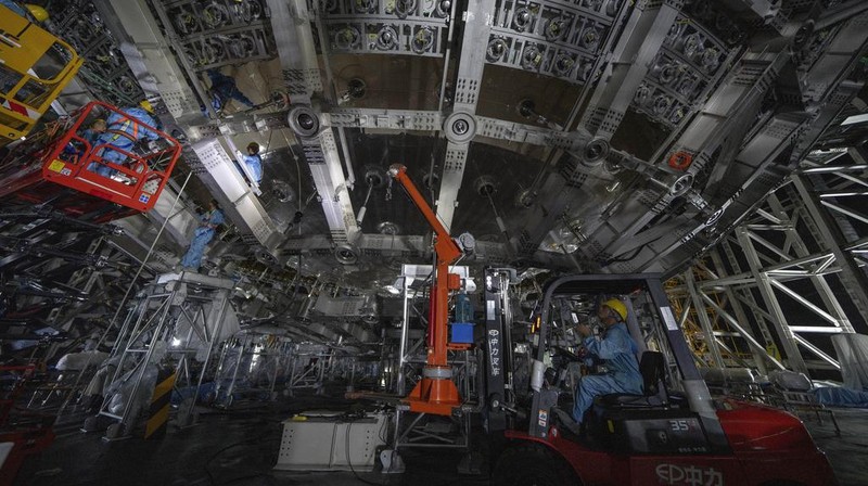 Workers labor on the underside of the cosmic detector located 2297 feet (700 meters) underground at the Jiangmen Underground Neutrino Observatory in Kaiping, southern China's Guangdong province on Friday, Oct. 11, 2024. (AP Photo/Ng Han Guan)
