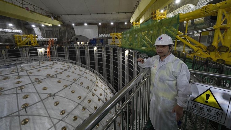 Workers labor on the underside of the cosmic detector located 2297 feet (700 meters) underground at the Jiangmen Underground Neutrino Observatory in Kaiping, southern Chinas Guangdong province on Friday, Oct. 11, 2024. (AP Photo/Ng Han Guan)