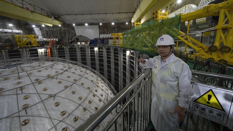 Workers labor on the underside of the cosmic detector located 2297 feet (700 meters) underground at the Jiangmen Underground Neutrino Observatory in Kaiping, southern China's Guangdong province on Friday, Oct. 11, 2024. (AP Photo/Ng Han Guan)