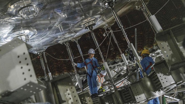 Workers labor on the underside of the cosmic detector located 2297 feet (700 meters) underground at the Jiangmen Underground Neutrino Observatory in Kaiping, southern Chinas Guangdong province on Friday, Oct. 11, 2024. (AP Photo/Ng Han Guan)