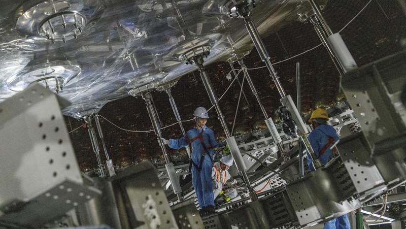 Workers labor on the underside of the cosmic detector located 2297 feet (700 meters) underground at the Jiangmen Underground Neutrino Observatory in Kaiping, southern China's Guangdong province on Friday, Oct. 11, 2024. (AP Photo/Ng Han Guan)