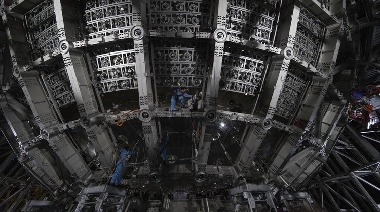 Workers labor on the underside of the cosmic detector located 2297 feet (700 meters) underground at the Jiangmen Underground Neutrino Observatory in Kaiping, southern Chinas Guangdong province on Friday, Oct. 11, 2024. (AP Photo/Ng Han Guan)