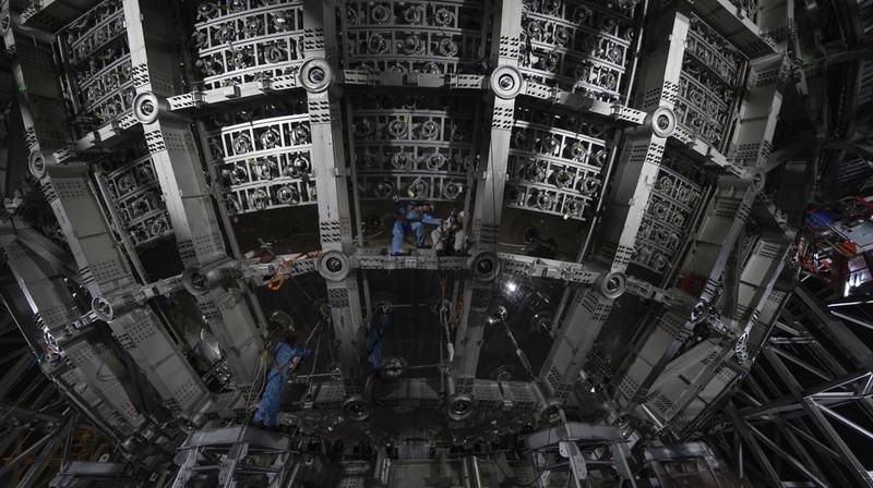 Workers labor on the underside of the cosmic detector located 2297 feet (700 meters) underground at the Jiangmen Underground Neutrino Observatory in Kaiping, southern China's Guangdong province on Friday, Oct. 11, 2024. (AP Photo/Ng Han Guan)