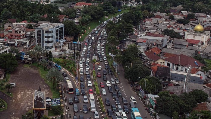 Foto udara kepadatan kendaraan saat diberlakukan sistem satu arah di Jalan Raya Puncak, Simpang Gadog, Ciawi, Kabupaten Bogor, Jawa Barat, Sabtu (21/12/2024). Polres Bogor memberlakukan sistem satu arah untuk mengurai kemacetan akibat tingginya volume kendaraan yang menuju jalur wisata Puncak, Bogor, untuk berlibur akhir pekan dan liburan sekolah. ANTARA FOTO/Yulius Satria Wijaya/nz.