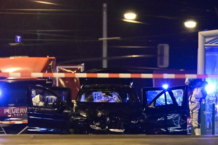 Forensics police inspect the car that rammed into a crowd at a Christmas market in Magdeburg, eastern Germany, on December 21, 2024. German police arrested a Saudi Arabian man after a deadly car-ramming attack on a Christmas market December 20, 2024 in which an SUV barrelled through a crowd of revellers at high speed, leaving a trail of bloody carnage. At least two people were killed, one of them a young child, and 68 injured, said authorities in the city of Magdeburg, located about 130 kilometres (80 miles) southwest of Berlin. Families were crowded at the market set up around a large Christmas tree in the centre of Magdeburg when a BMW barrelled towards them around 7 pm (1800 GMT). (Photo by John MACDOUGALL / AFP)